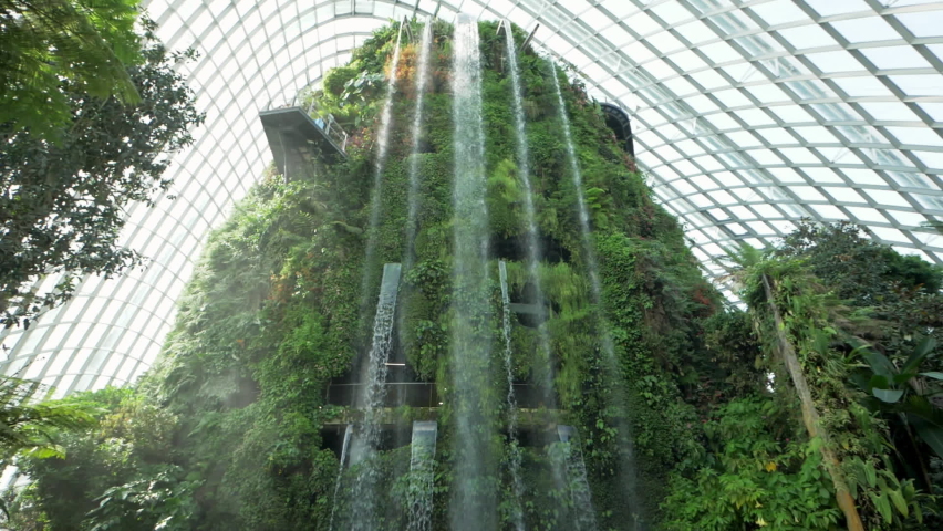 Waterfall inside of the Cloud Forest Dome at Gardens by the Bay in Singapore. Slowmotion Royalty-Free Stock Footage #1094726277
