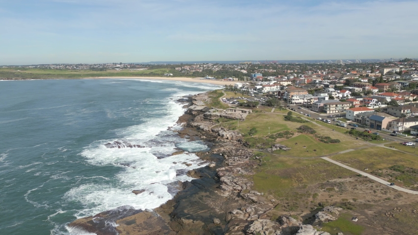 Aerial panorama view of Maroubra Beach coastline in Sydney, Australia. Drone flying straight toward the beach.