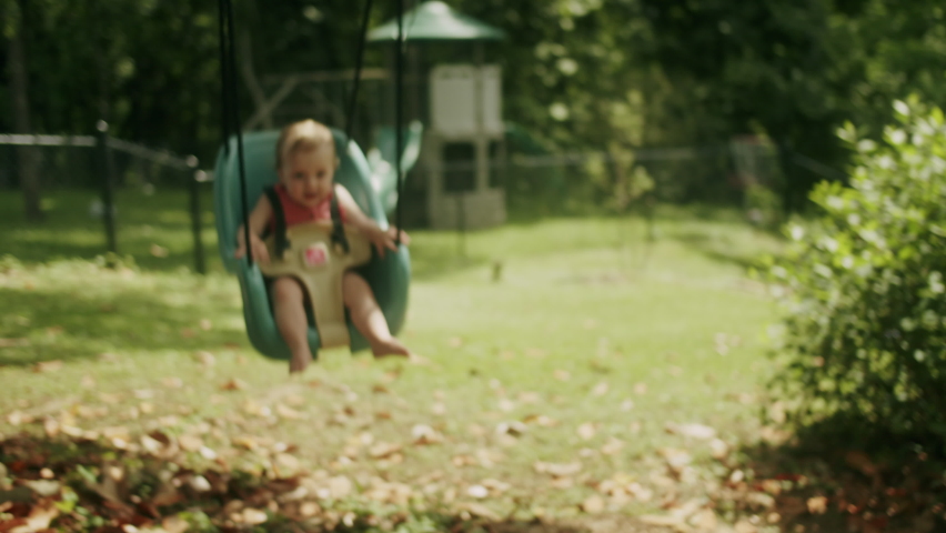 Mother pushing baby on a swing | Shutterstock HD Video #1094732071