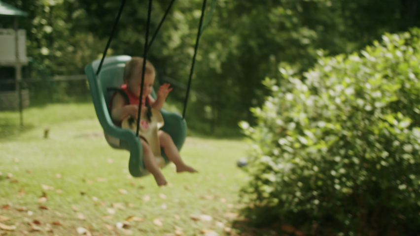 Mother pushing baby on a swing | Shutterstock HD Video #1094732075