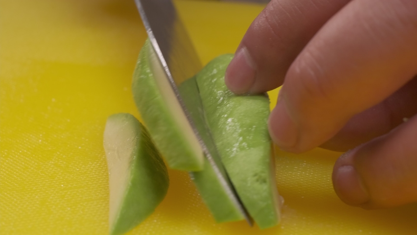 Avocado being cut into slices on a board by a chef | Shutterstock HD Video #1094732535