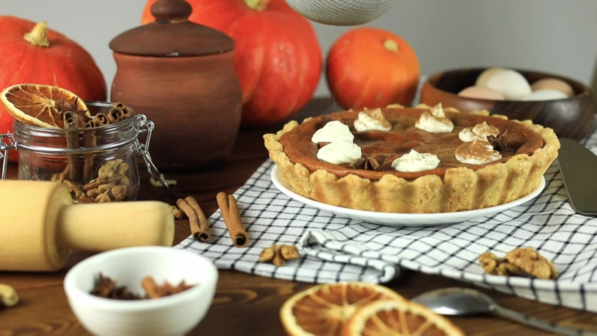 Freshly baked pumpkin pie sprinkled with fragrant cinnamon on top