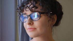 Portrait of beautiful Ukrainian woman in glasses looking away and thinking positive. 4k stock video clip of natural looking young girl wearing eyeglasses