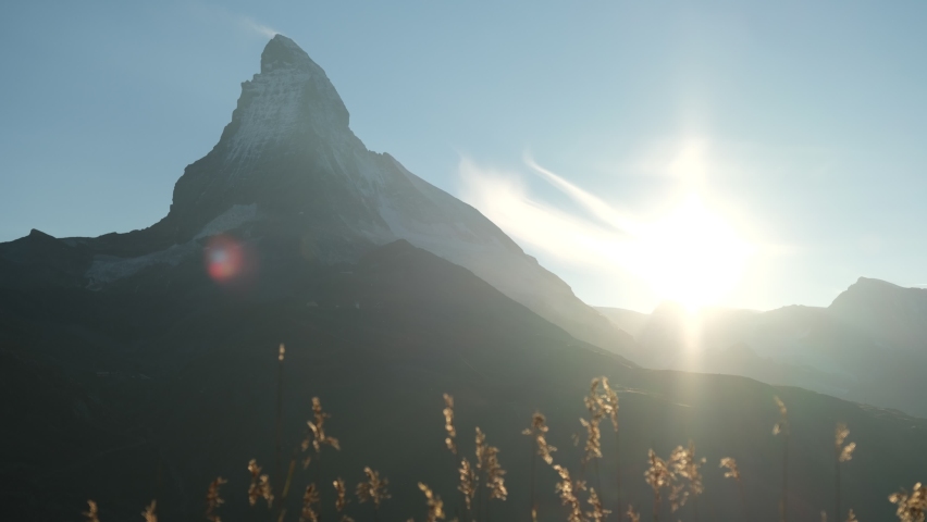 4K time lapse of sunset that shading on the peak of Matterhorn mountain at Zermatt, Switzerland. with clear blue sky during summer that starting to getting into winter season.  | Shutterstock HD Video #1094739581