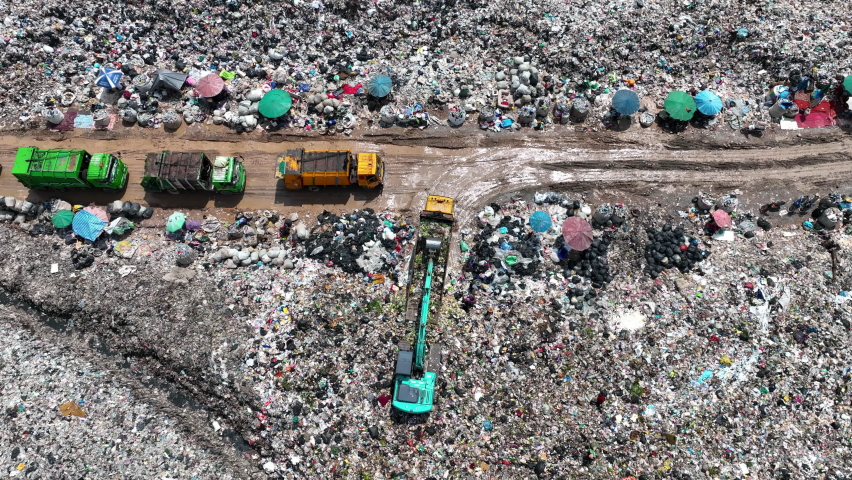 Garbage trucks unload garbage over the landfill. Pollution concept. | Shutterstock HD Video #1094739647