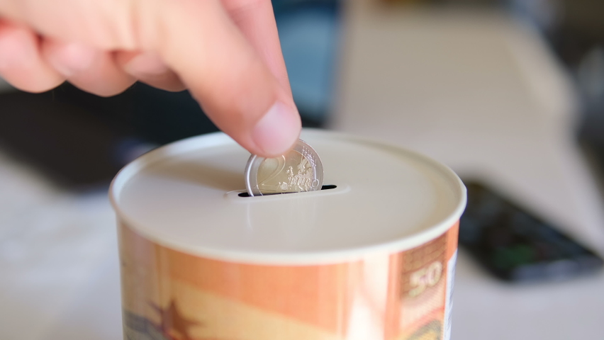 Man insert euro coins on a money box to accumulate family saving in economical crisis period - Powered by Shutterstock - Get 15% off with code: PIKWIZARD15
