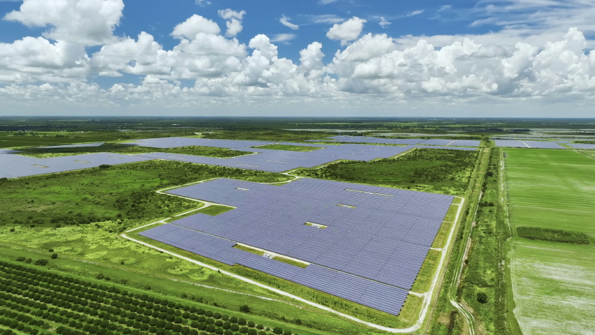 Aerial view of big sustainable electric power plant with many rows of solar photovoltaic panels for producing clean electrical energy. Renewable electricity with zero emission concept Royalty-Free Stock Footage #1094749919