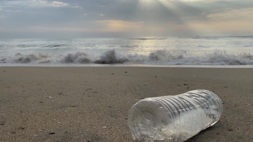 Water Pollution - Contamination of marine aquatic life - Transparent plastic water bottle floating on the sea shore, polluting the environment - Failure of seaside preservation by irresponsible people | Shutterstock HD Video #1094752341
