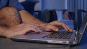 close-up, the hands of a male video editor are processing on a laptop in the studio.