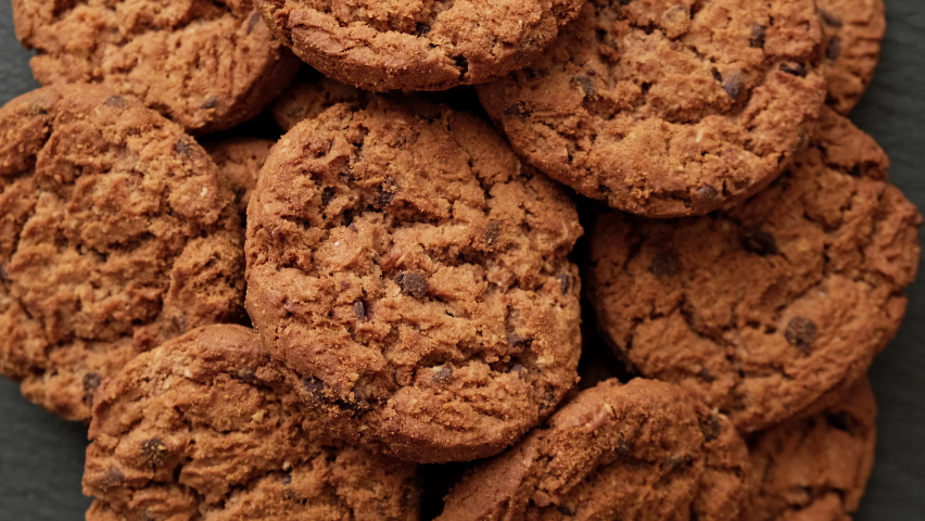 Fresh oatmeal cookies rotating. Food concept. Homemade cookies with chocolate. Stack of whole meal cookies. Close-up in 4K, UHD | Shutterstock HD Video #1094756311