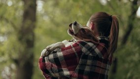 Little beagle puppy with his owner in beautiful autumn field. Woman hugging dog on nature backdrop. Cute lovely pet, new member of family. - Powered by Shutterstock - Get 15% off with code: PIKWIZARD15