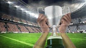 Animation of confetti falling over caucasian man holding silver cup in rugby field in sports stadium. sports, winning and competition concept digitally generated video.