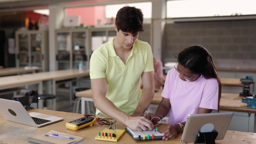 Diverse young high school students learning in science robotics or electronic engineering class | Shutterstock HD Video #1094762547