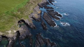 Black rocks on the shore. Beautiful seascape. Seaside area of the Ireland. Blue waters of the Atlantic, aerial video in full hd.