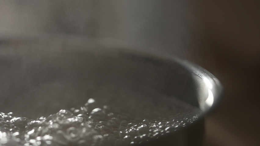Slow motion water boiling in pot closeup Royalty-Free Stock Footage #1094767159