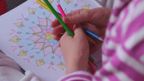 Female painting mandalas antistress page to combat stress. Relaxing hobby mental wellbeing and art therapy. Woman paints sketch, meditative process of coloring pages. Self expression by art 4k  - Powered by Shutterstock - Get 15% off with code: PIKWIZARD15