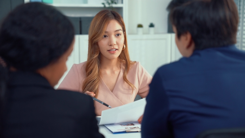 A young female asian candidate tries to impress her interviewer by being competent. International company, multicultural environment in workplace.