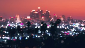 Blurred city lights at scenic evening with pink skies and Los Angeles downtown in bokeh effect. Defocused night city at sunset. Cityscape with skyscrapers night out of focus lights. City night scene - Powered by Shutterstock - Get 15% off with code: PIKWIZARD15