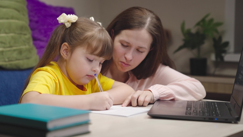 Happy mother child write lessons with pen notebook. online lessons internet laptop. smart modern technology. smart home concept. childhood with parent lessons children room. home education computer. | Shutterstock HD Video #1094783275
