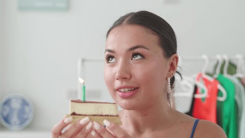 Elegant Asian Woman Makes Wish Blowing Stock Footage Video (100%