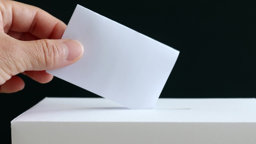 Business concept with hands and graphs to put votes in the ballot box.