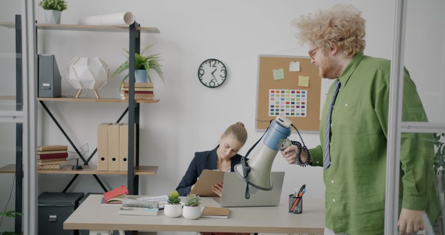 Funny evil guy mean boss is yelling at scared subordinates using megaphone in office. Corporate relationship and negative emotions concept.