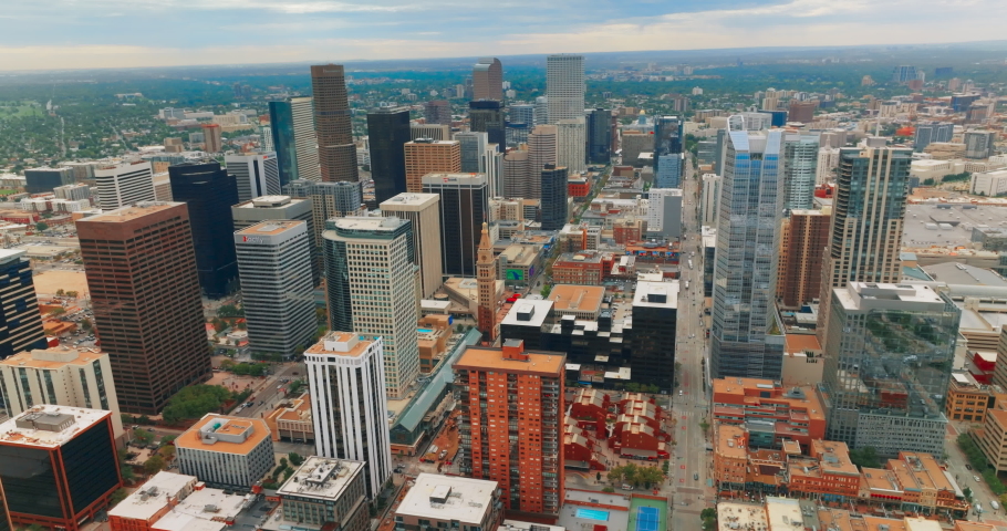 Contemporary downtown of Denver, Colorado, USA at cloudy daytime. Endless urban cityscape at backdrop of overcast sky. Top view.
