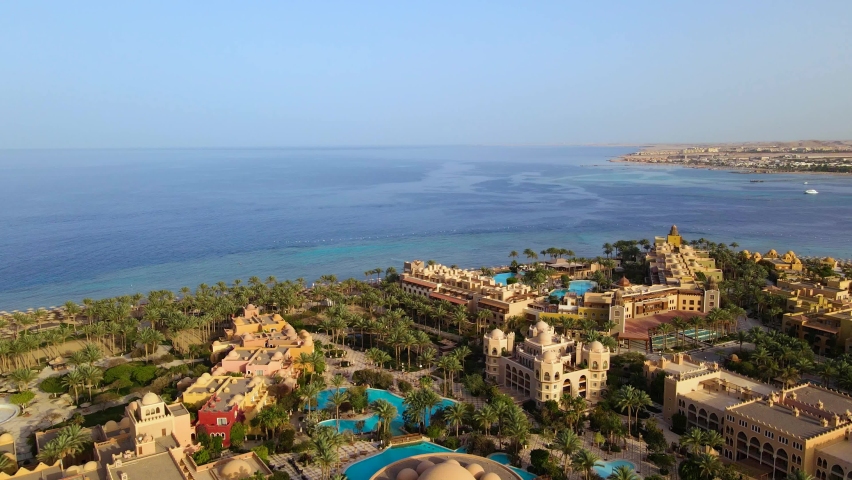 Al Hurghada beach town and resort in Egypt as viewed from the sky.. Egypt's Red Sea coast as seen from the air. This shot was taken on a sunny clear day Royalty-Free Stock Footage #1094793631