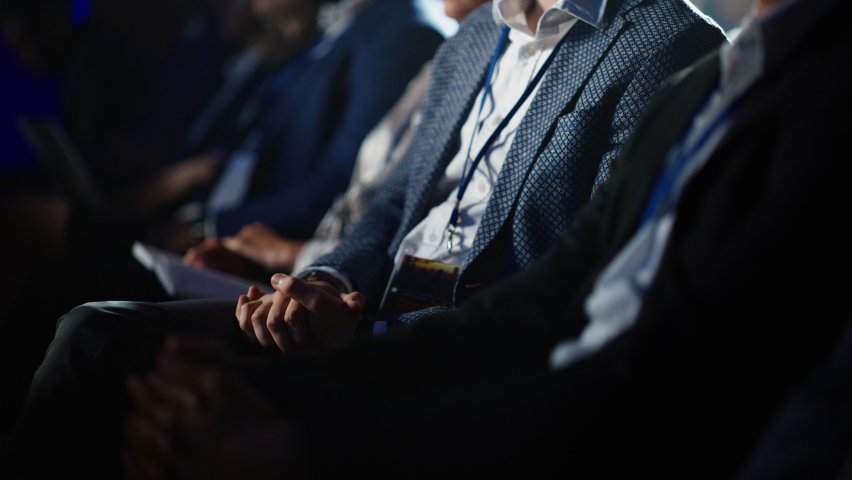Close Up on Hands of an Audience of People Applauding in Dark Concert Hall During a Business Conference Presentation. Technology Summit Auditorium Room Full of Corporate Delegates. Royalty-Free Stock Footage #1094794997