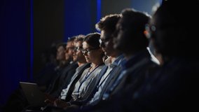 Young Woman Sitting in Crowded Audience at a Business Conference. Female Delegate Smiling and Using Laptop Computer. Manager Watching Motivational Presentation About Angel Investing. Slow Motion Shot. - Powered by Shutterstock - Get 15% off with code: PIKWIZARD15