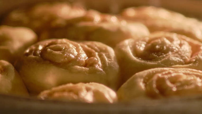 Cinnamon buns in the oven are cooked on a dish, timelapse. Process of making cinnamon rolls in home kitchen Royalty-Free Stock Footage #1094804989
