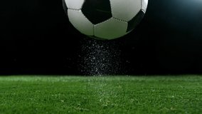 Super slow motion of falling soccer ball on lawn. Speed ramp effect. Filmed on high speed cinema camera, 1000fps. - Powered by Shutterstock - Get 15% off with code: PIKWIZARD15