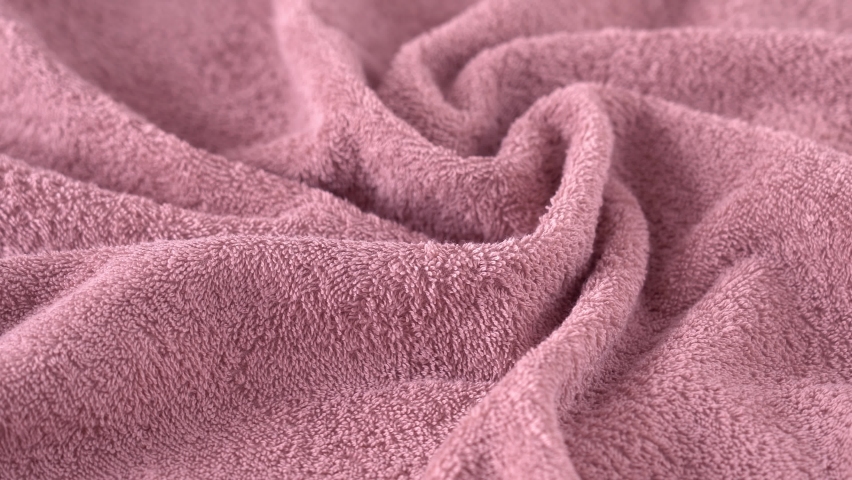 Fresh pink cotton terry towel rotates on board. Bathing, hygiene, washing and cleanliness concept. Textile industry Royalty-Free Stock Footage #1094806577