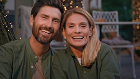 Portrait front view closeup funny two people smiling toothy Caucasian married couple happy 40s spouses bearded husband and blonde wife laugh smile with white teeth dental laughing outdoors near lights