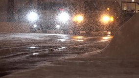 SAPPORO, HOKKAIDO, JAPAN - FEB 2020 : Snow scenery around Susukino city at night. View of snow falling at downtown street. Japanese cold winter and snowing season concept video. Slow motion shot.