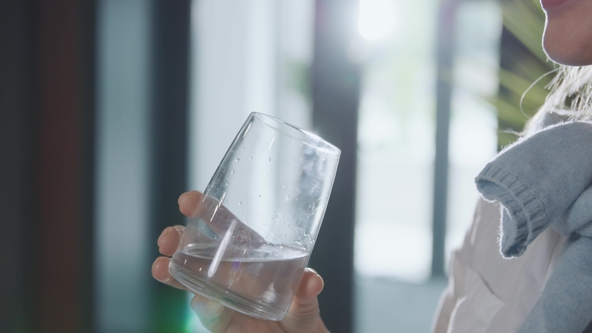 Close up portrait woman drink water from glass indoors. Sunshine. Stand in room. Smiling. Water balance. Health. Slow motion Royalty-Free Stock Footage #1094811907