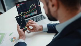 Close-up of laptop and smart phone screen with stock diagrams.Caucasian crypto trader investor using cellphone and laptop for cryptocurrency financial market analysis, buying or selling cryptocurrency - Powered by Shutterstock - Get 15% off with code: PIKWIZARD15
