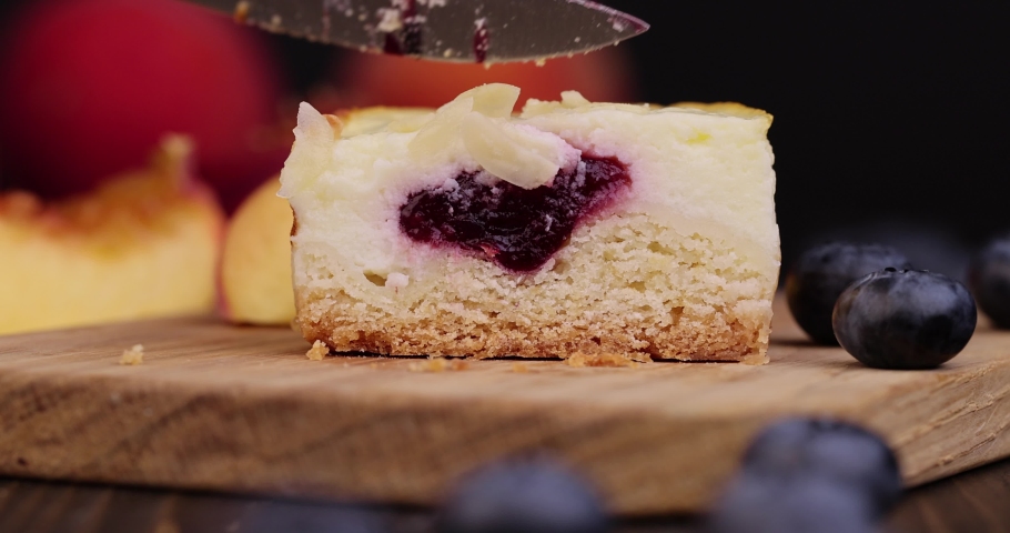 Mini cheesecake cake with fruit blueberry filling, cheese cream cake with blueberries on a wooden board | Shutterstock HD Video #1094816247