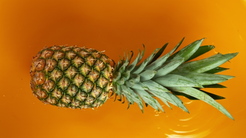 Super Slow Motion Shot of Splashing Fresh Pineapple. Filmed on High Speed Cinematic Camera at 1000fps.