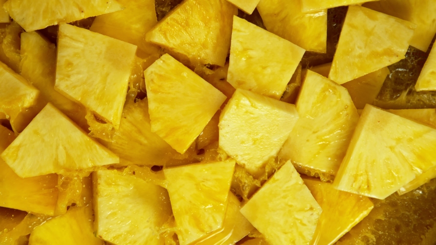 Super Slow Motion Shot of Splashing Fresh Pineapple Pieces. Filmed on High Speed Cinematic Camera at 1000fps.