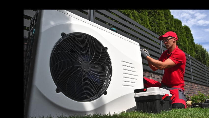 Professional HVAC Worker in His 40s Installing Swimming Pool Heat Pump Outdoor Water Heating Device. Energy Saving Technologies. | Shutterstock HD Video #1094819763