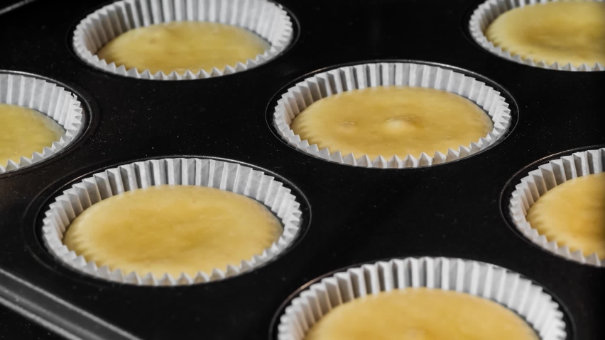 Timelapse - cupcakes, muffins baking and rising in muffin tin in electric oven - close up, macro, zoom in shot. Homemade bakery, food, cooking, pastry and time lapse concept Royalty-Free Stock Footage #1094822309
