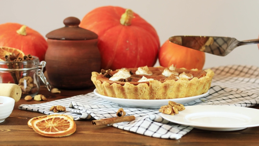 A piece of pumpkin pie is laid out on a plate