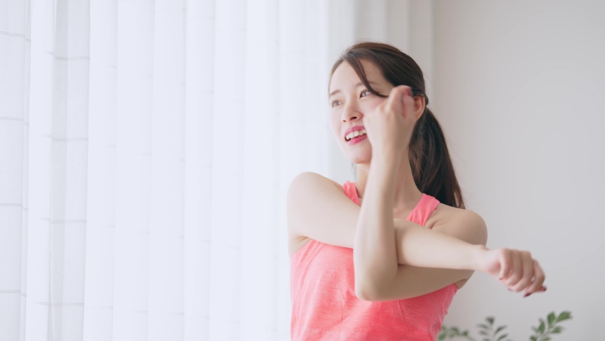 Young Asian woman stretching in the room. | Shutterstock HD Video #1094824115