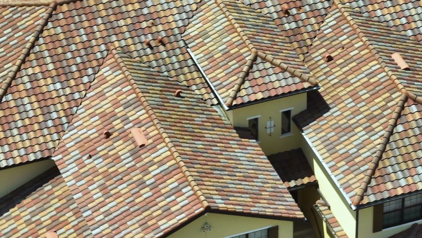 Closeup of house roof top covered with ceramic shingles. Tiled covering of building Royalty-Free Stock Footage #1094824687