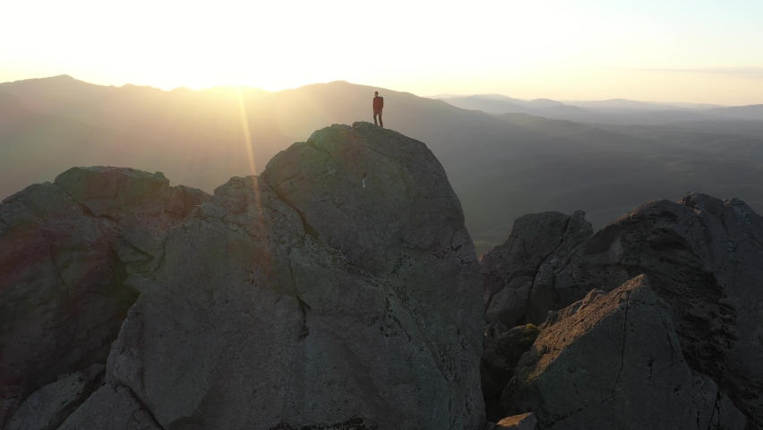 Traveler Reaching Top of Mountain and Hands Raising in a Sunset Light. Royalty-Free Stock Footage #1094828431