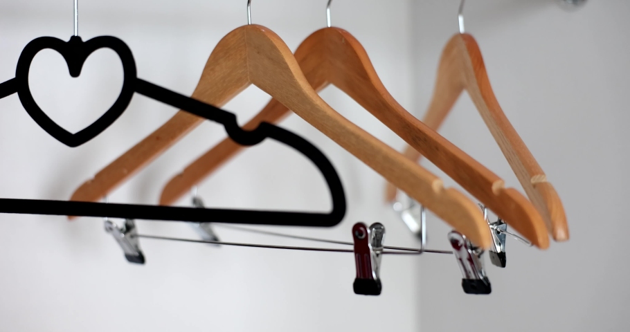 Many empty hangers hanging in closet closeup 4k movie slow motion | Shutterstock HD Video #1094829297
