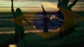 Composite video of waving brazil flag over group of friends with sparklers dancing at the beach. Global tourism and travel concept