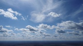 Clouds in blue sky. High altitude video. Earth nature background.  Environment scene.  Green earth texture. Panoramic footage.
