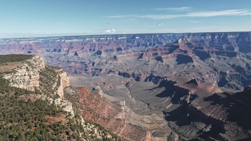 Cinematic aerial helicopter footage of Grand Canyon National Park in Arizona. Panoramic of famous Grand Canyon of Colorado river with red sandstone rocks.